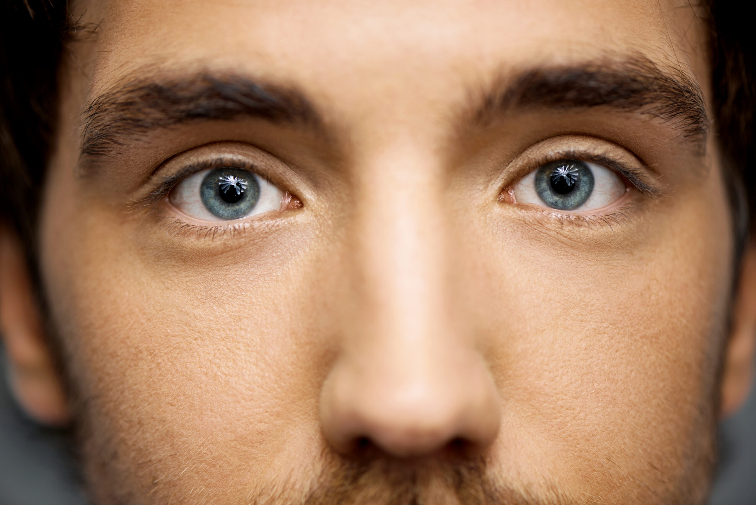 close up portrait of handsome young man staring at camera.