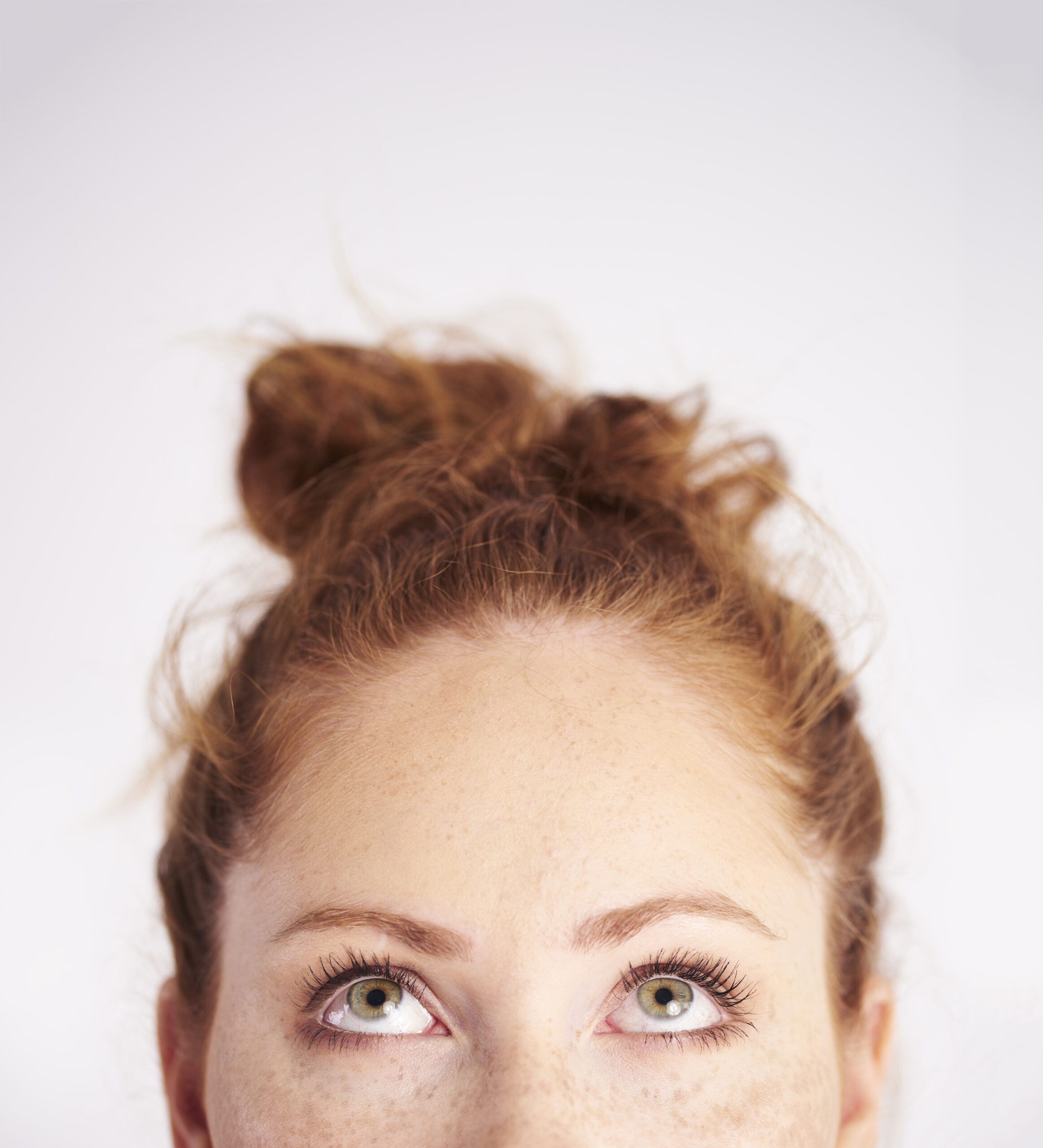 part of young woman looking up at studio shot